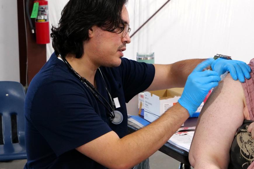 UCSF OEM Alumni, Ignacio Santana helping a patient
